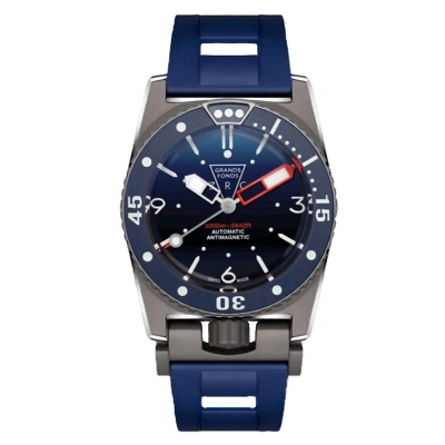 Frontal gezeigte Taucheruhr mit dunkelblauem Kautschukband. Schwarz-blaue Drehl&uuml;nette mit wei&szlig;en Leuchtpunkten, Dreiecksmarke oben, Zahlen 30/45/0/15/3/6/9/12 sichtbar.