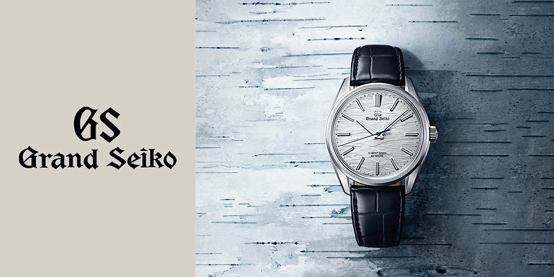 Marken&uuml;bersicht Grand Seiko: Die elegante Dresswatch im Evolution 9 Style zeigt ein graues, strukturiertes Zifferblatt und ein schwarzes Alligatorlederband. Handaufzug, hohe Pr&auml;zision und 80 Stunden Gangautonomie machen sie zu einem Meisterwerk.